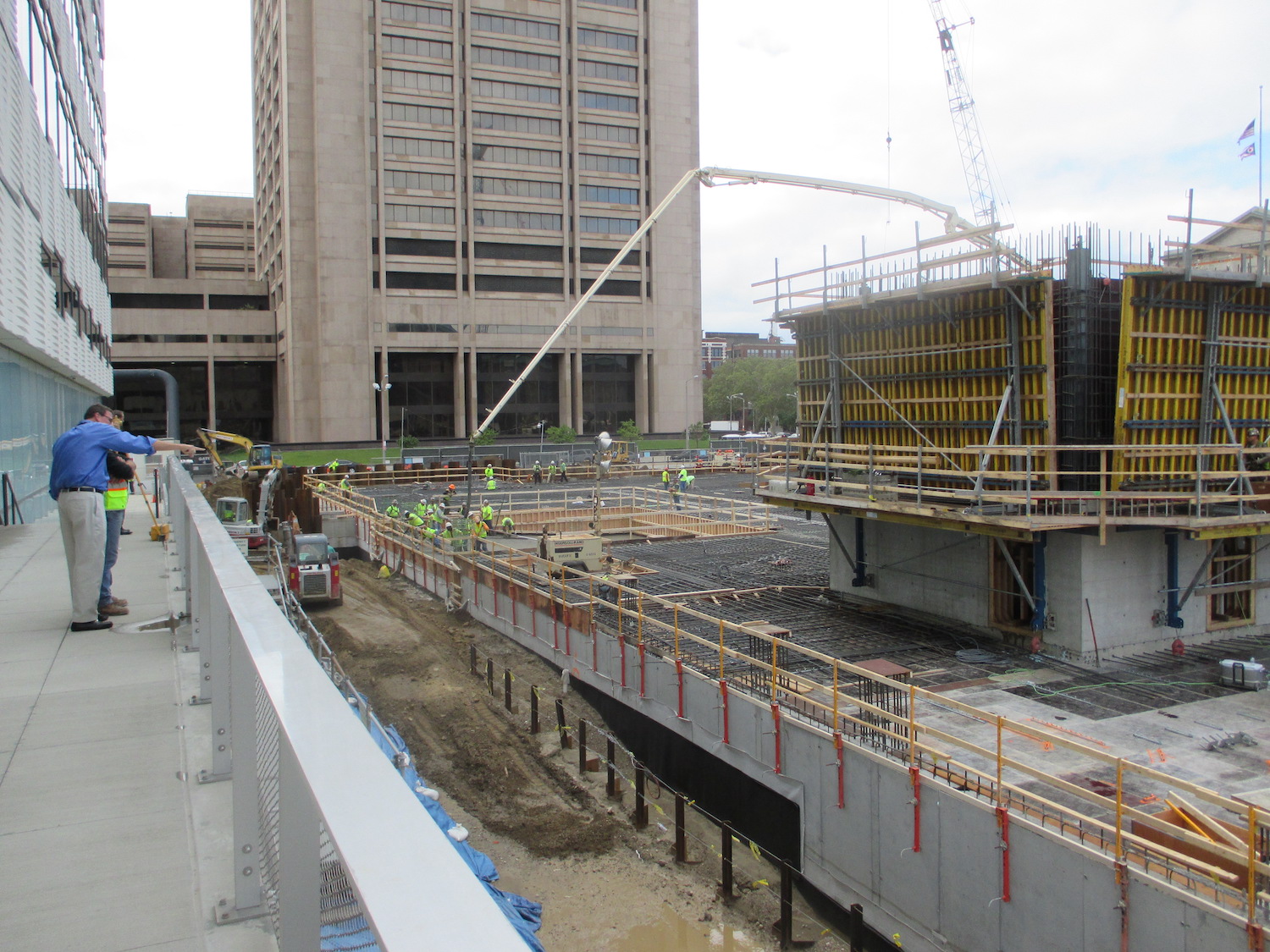 The beginning process of the Hilton Hotel process includes the construction workers laying the metal framing before pouring.