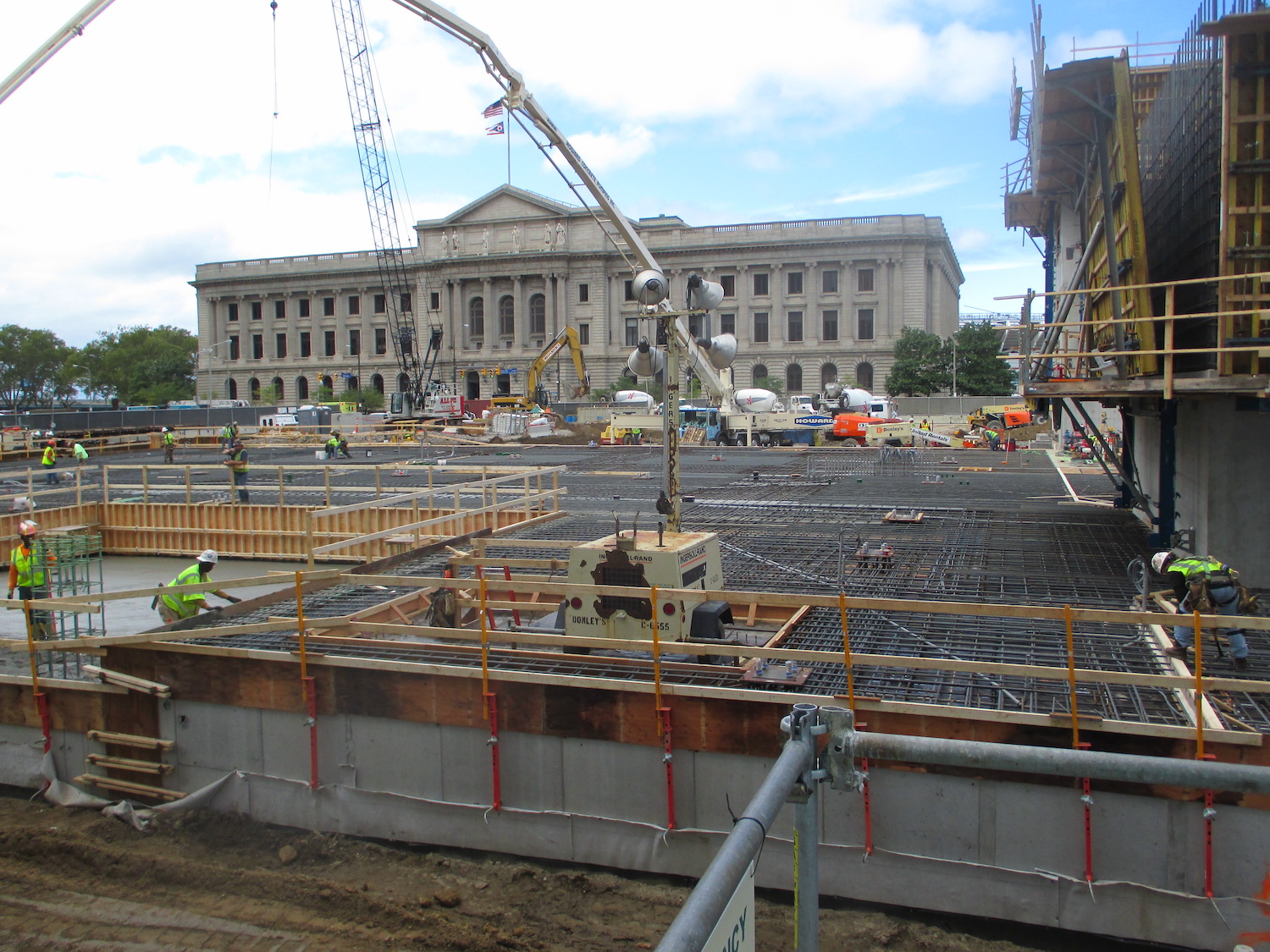 The beginning process of the Hilton Hotel process includes the construction workers laying the metal framing before pouring.