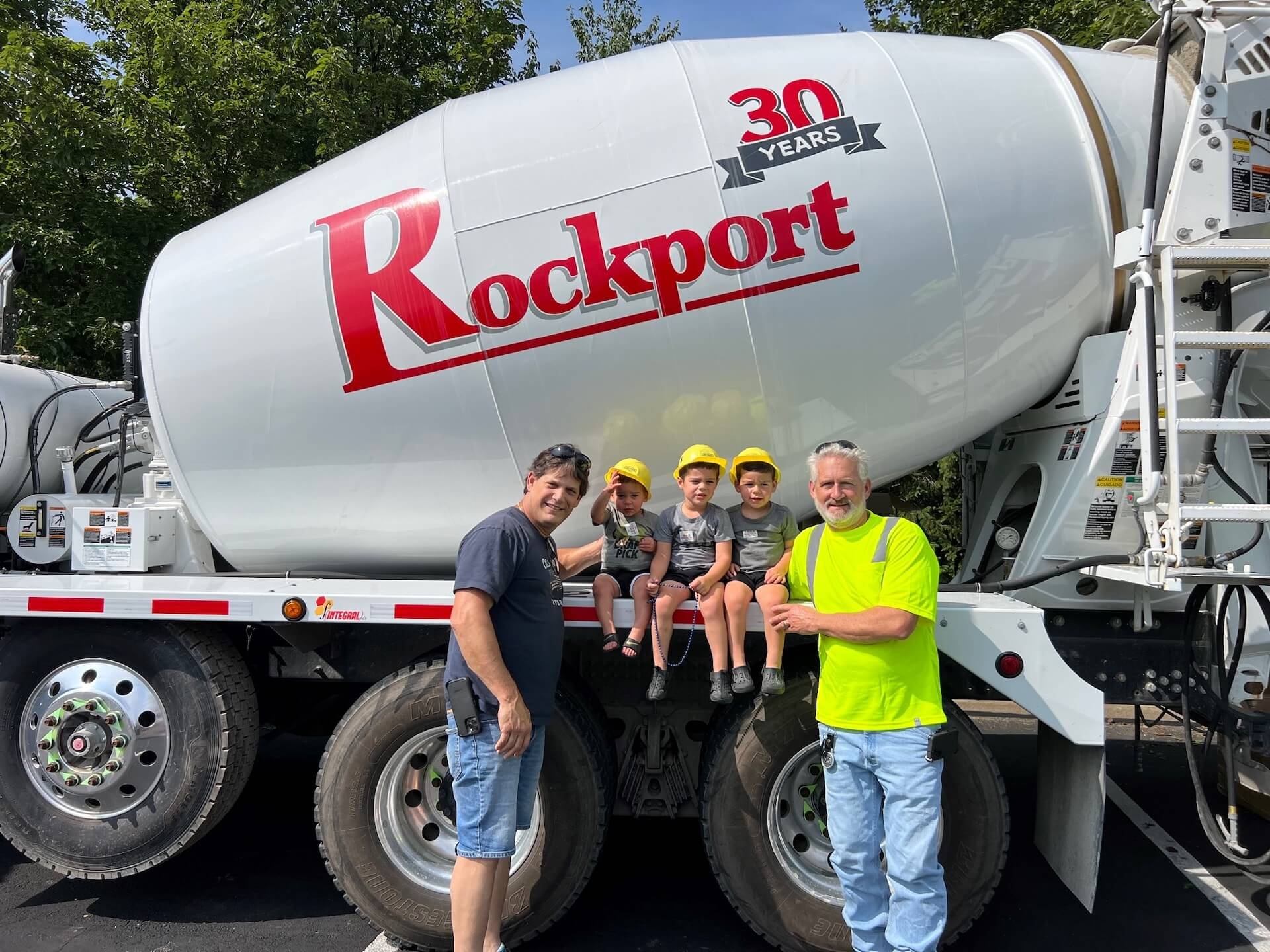 Gift of Giving; Rockport employees with kids in hard hats